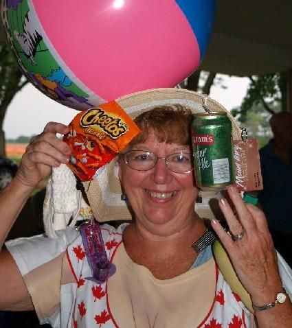 Picnicking parishioners show hats they won’t wear to church