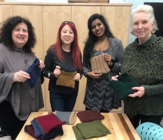 Lap Tapestry Project volunteers donate hand knitted items to those in need