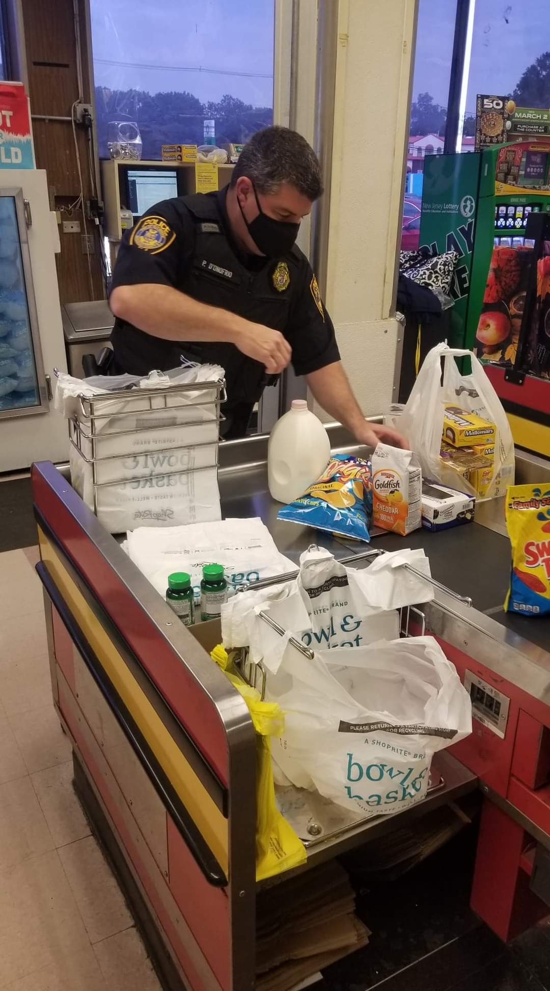 Members of Old Bridge PBA Local 127 bag groceries at ShopRite in support of National Hunger Action Month