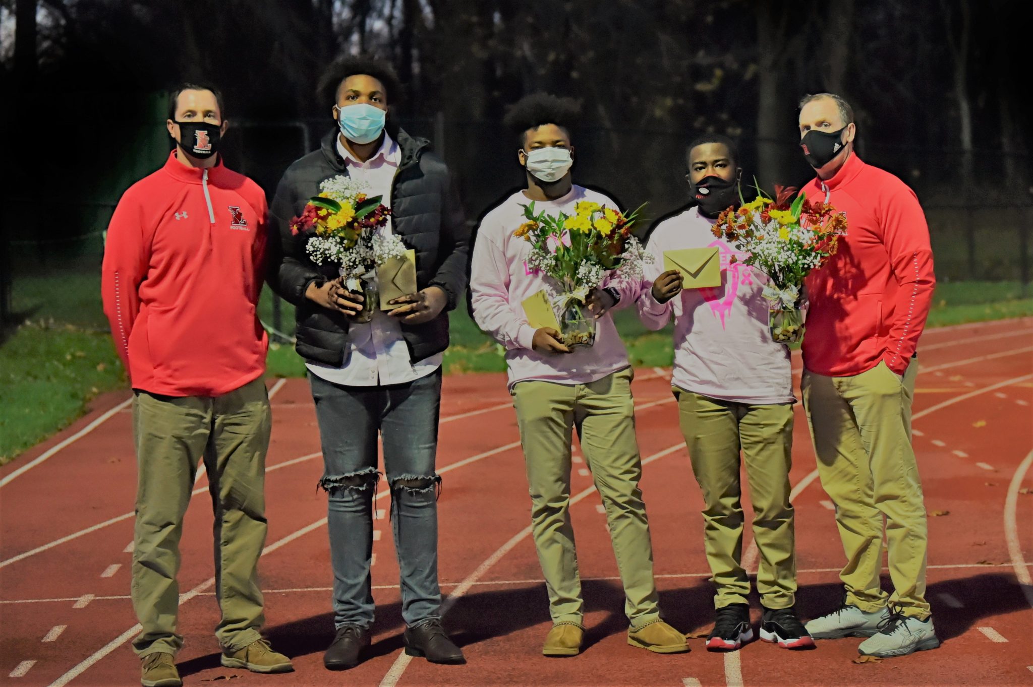 Lawrence High School football players surprise residents with kindness