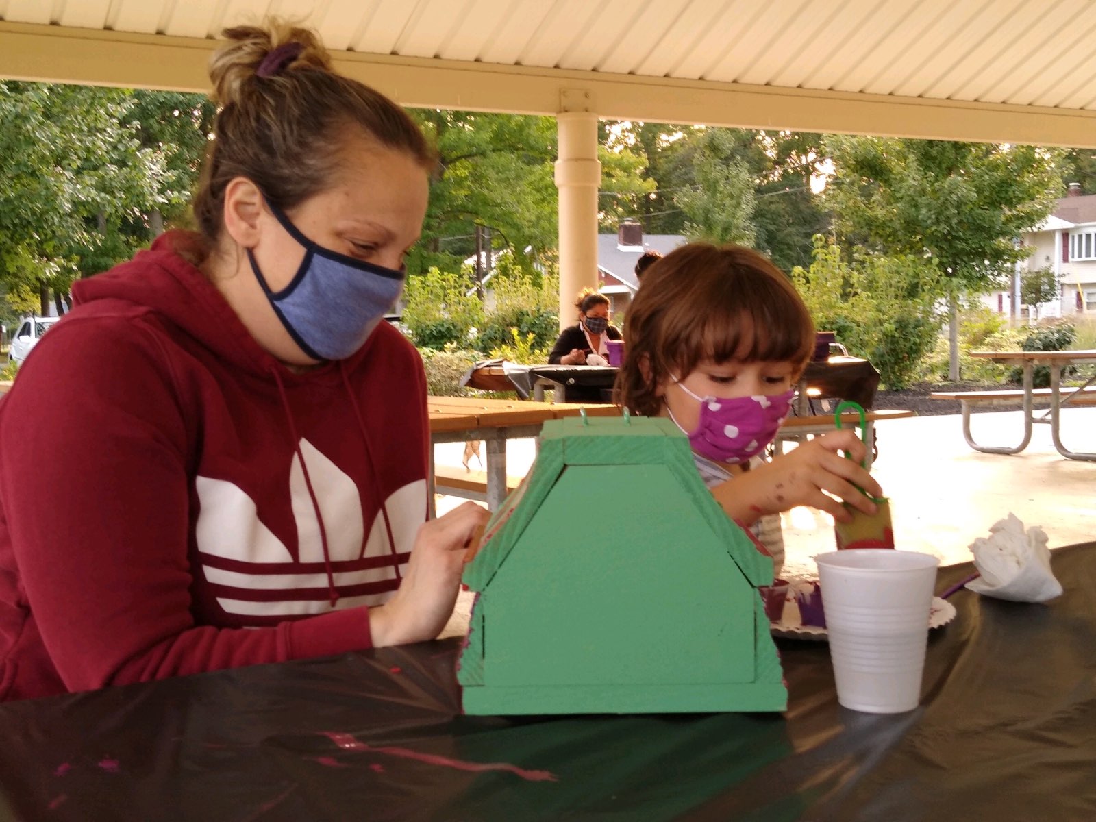 Residents enjoy painting birdhouses in the park