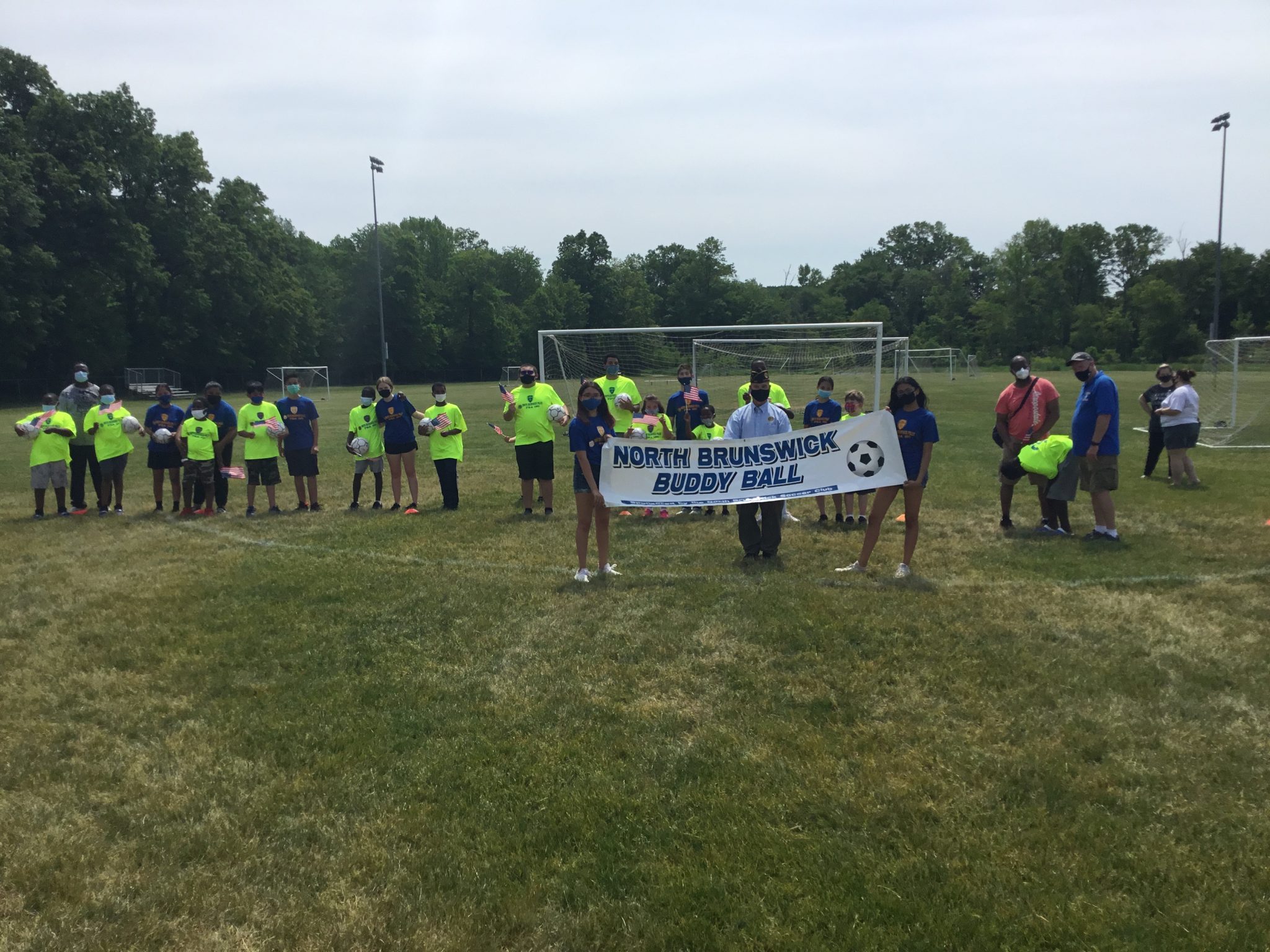 North Brunswick Buddy Ball members present flags before Memorial Day