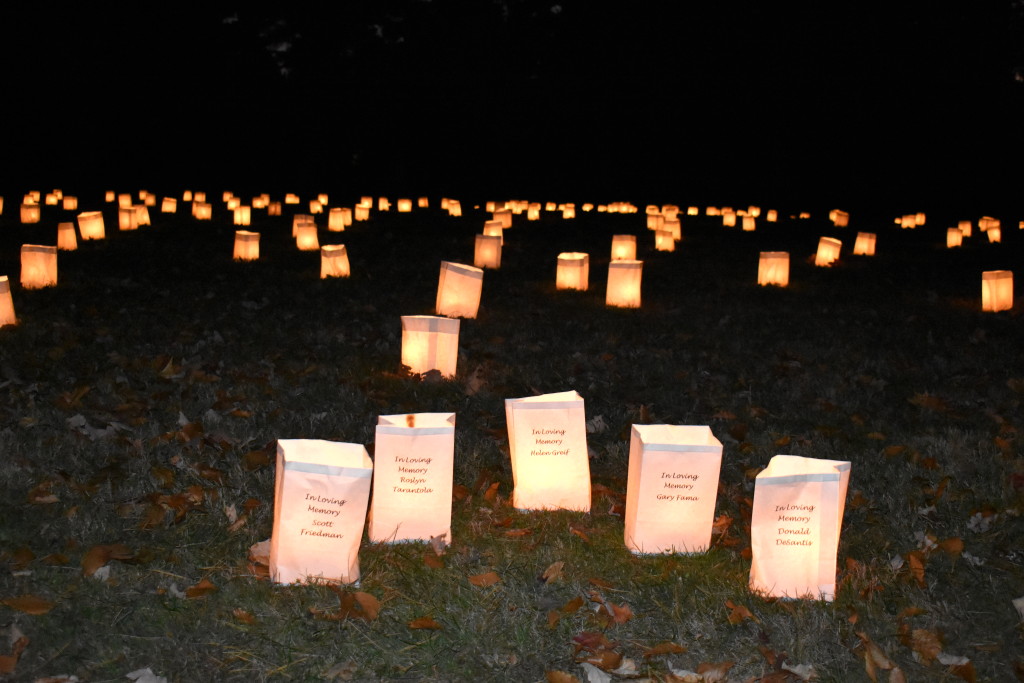 Luminary candles illuminate Elmwood Cemetery