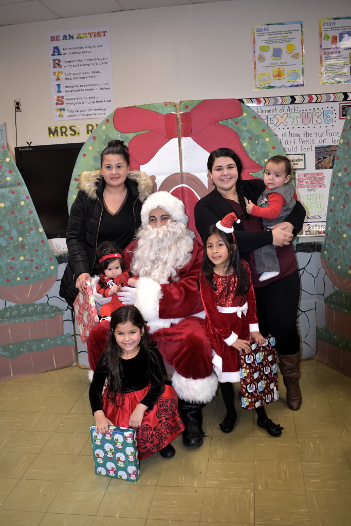 Santa, North Brunswick police officers deliver gifts donated by Middlesex County court employees during Mobile Family Success Center holiday party at Parsons Elementary