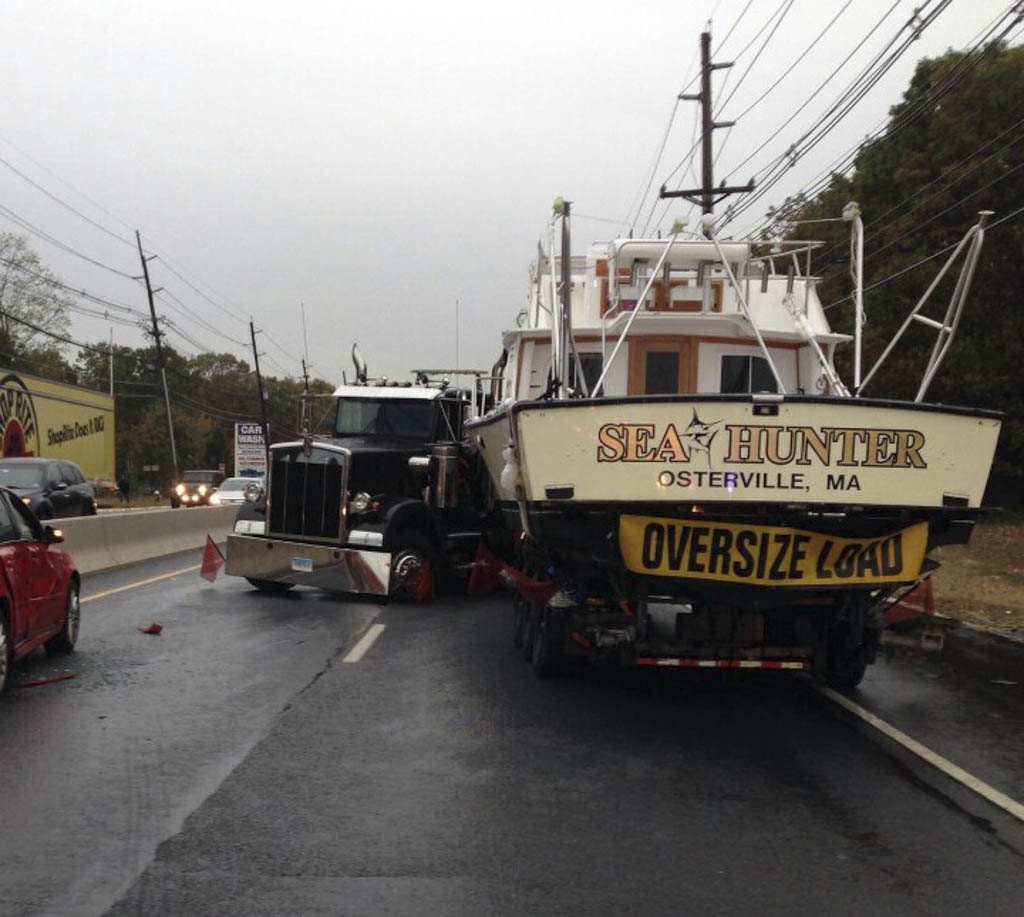 Tractor trailer carrying boat jackknifes, causes multi-vehicle accident