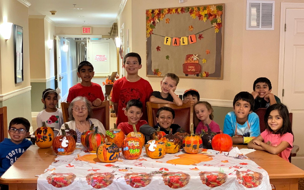 Cub Scout Pack 223 paints pumpkins with residents of the Chelsea