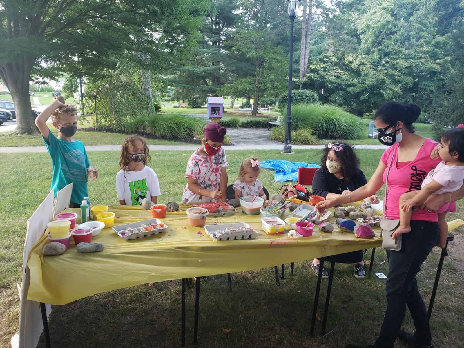 MOMS Club members paint stones to remember those lost to slavery