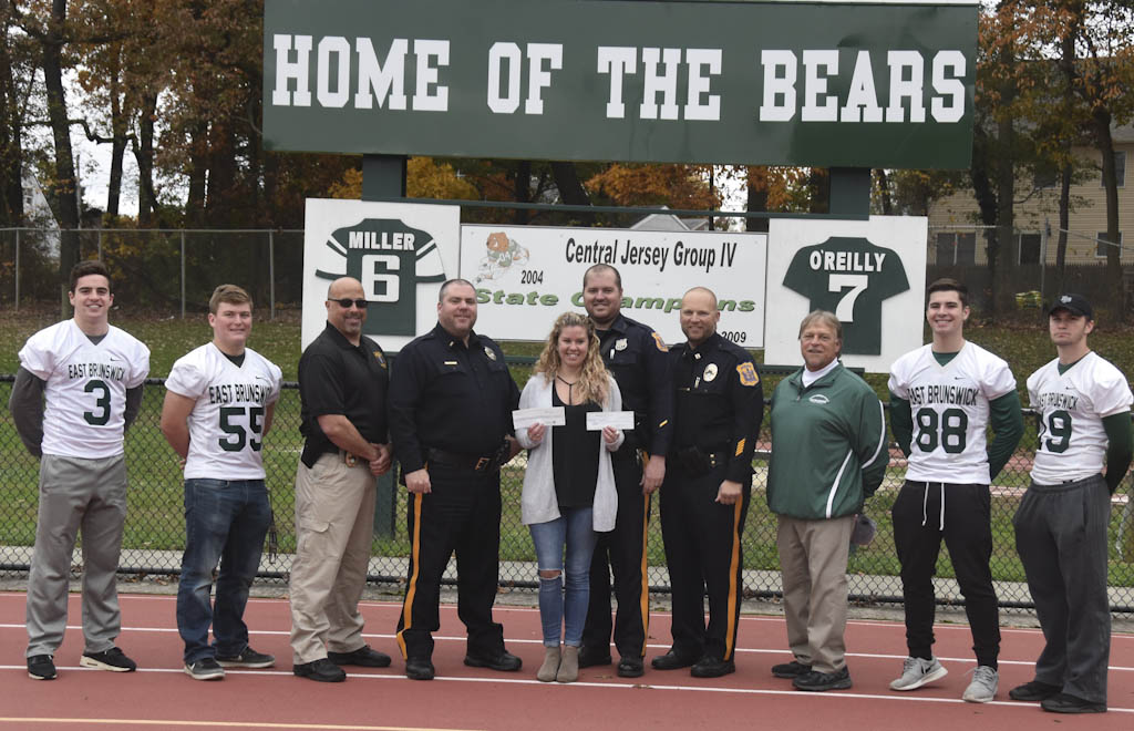 East Brunswick police and football team raise money for breast cancer