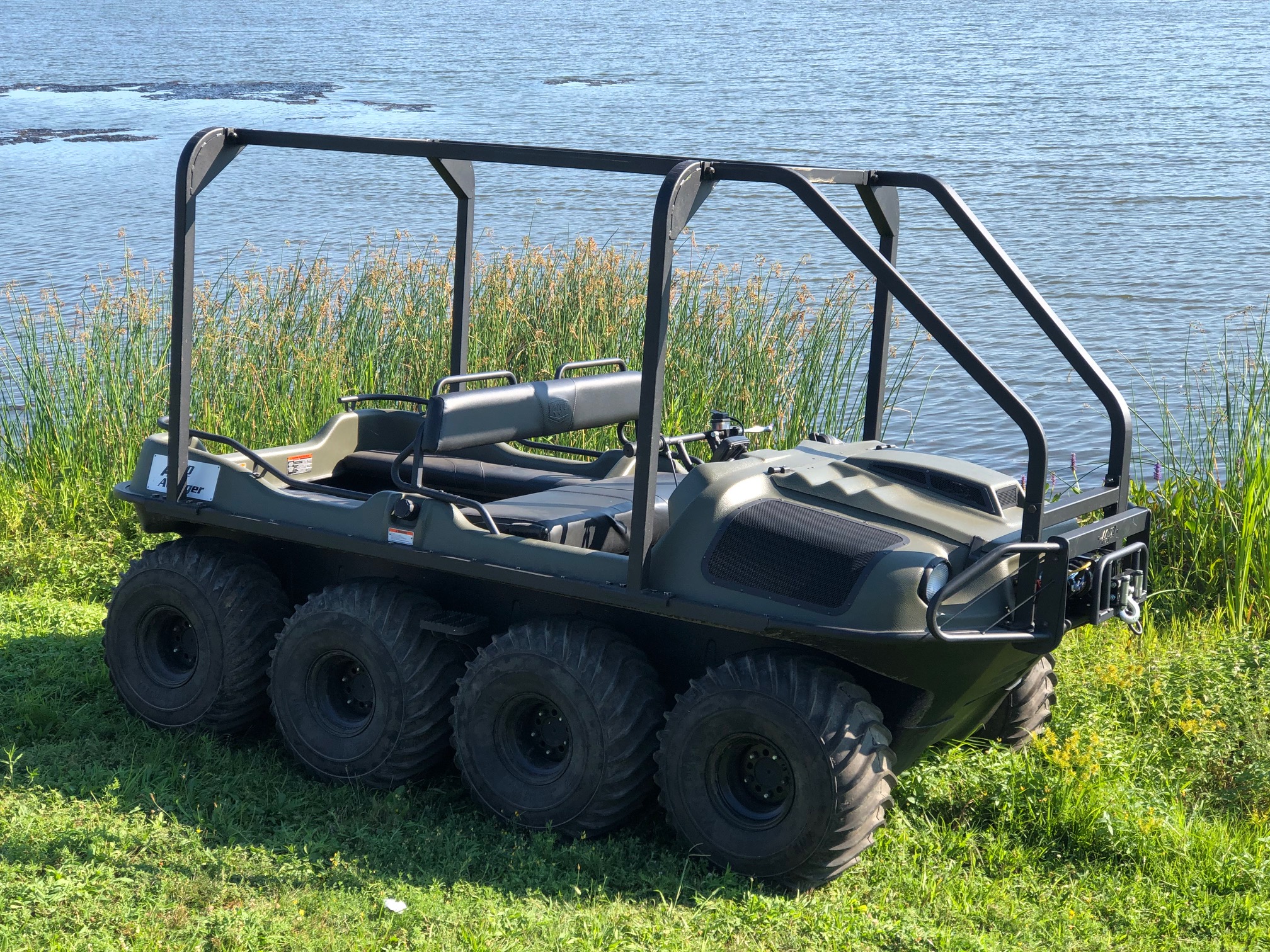 Monroe DPW workers retrieve trampoline from retention pond using amphibious all-terrain vehicle