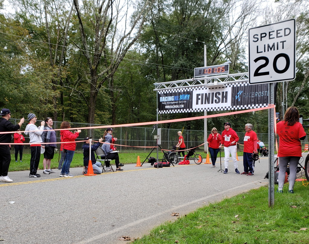 Collura crosses finish line during 5K held in his honor