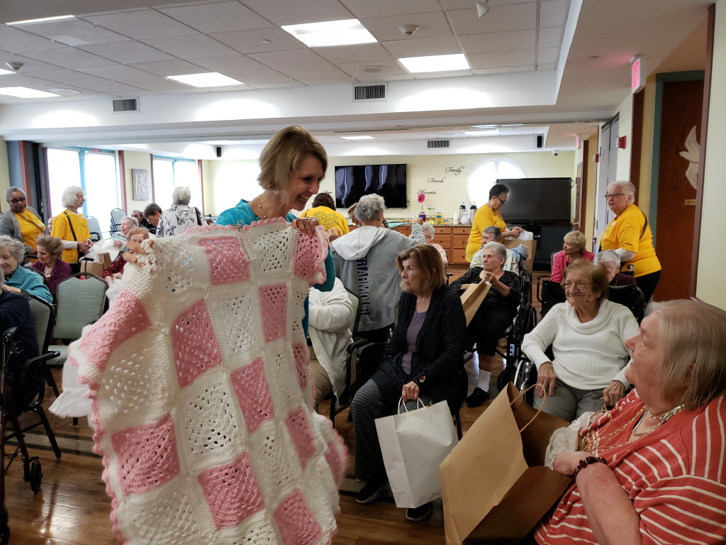 Silver Linings at Old Bridge present lap blankets for residents at assisted living facility