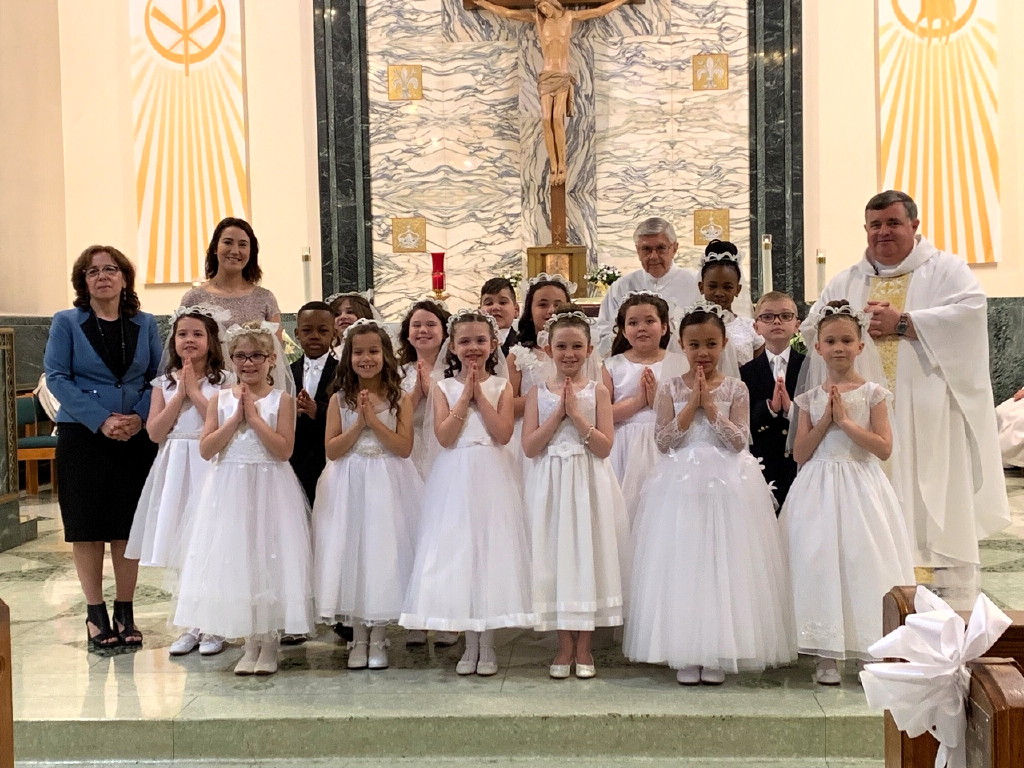 Our Lady of Victories second graders receive First Holy Communion